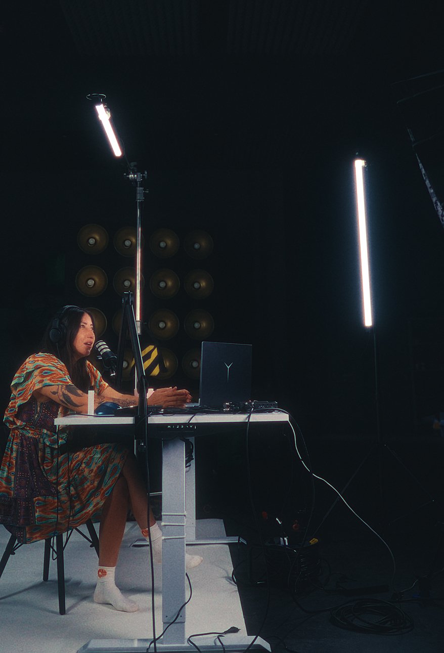 Speaker on a lit set with a softbox and accent lighting during a session
