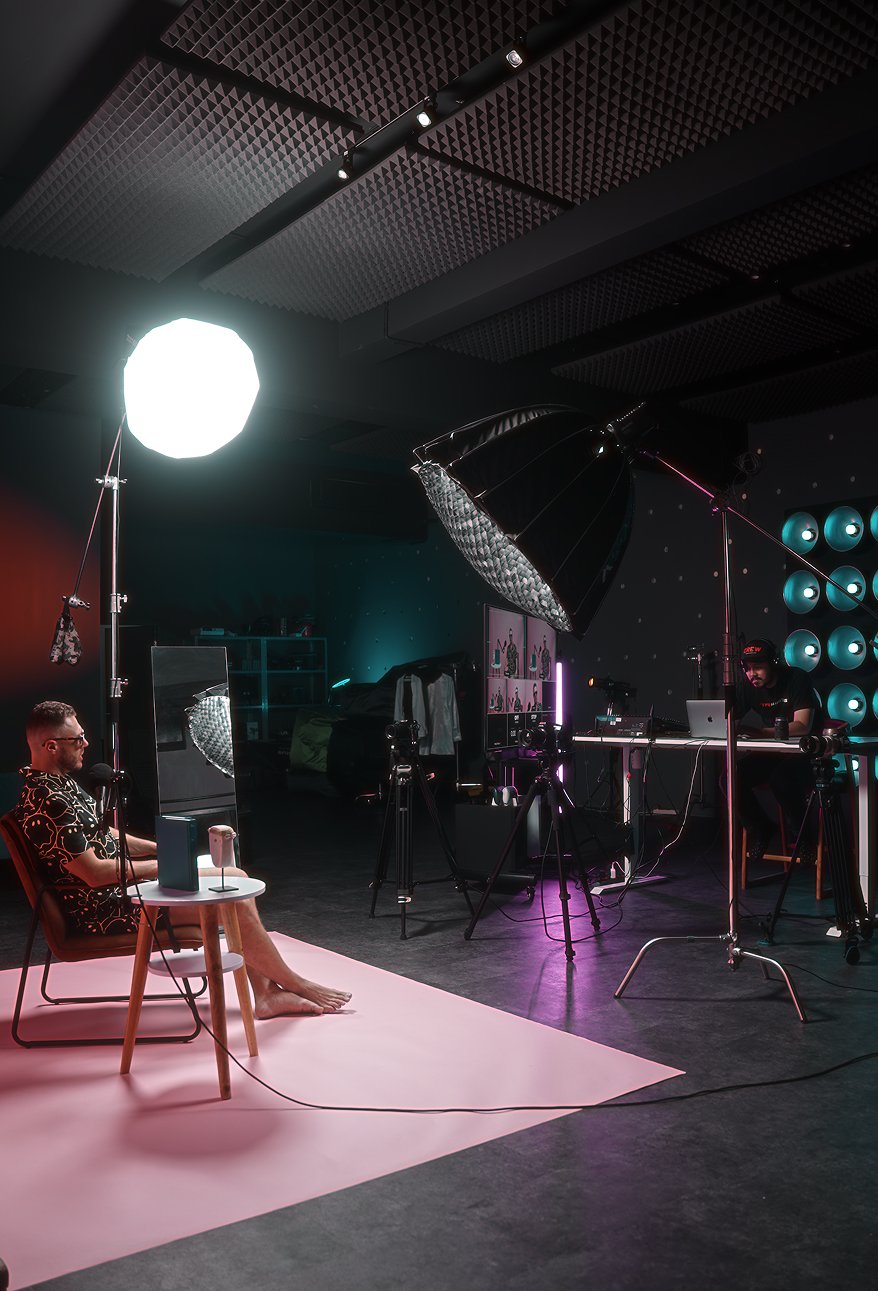 Guest on camera while the operator works at a laptop behind the scenes